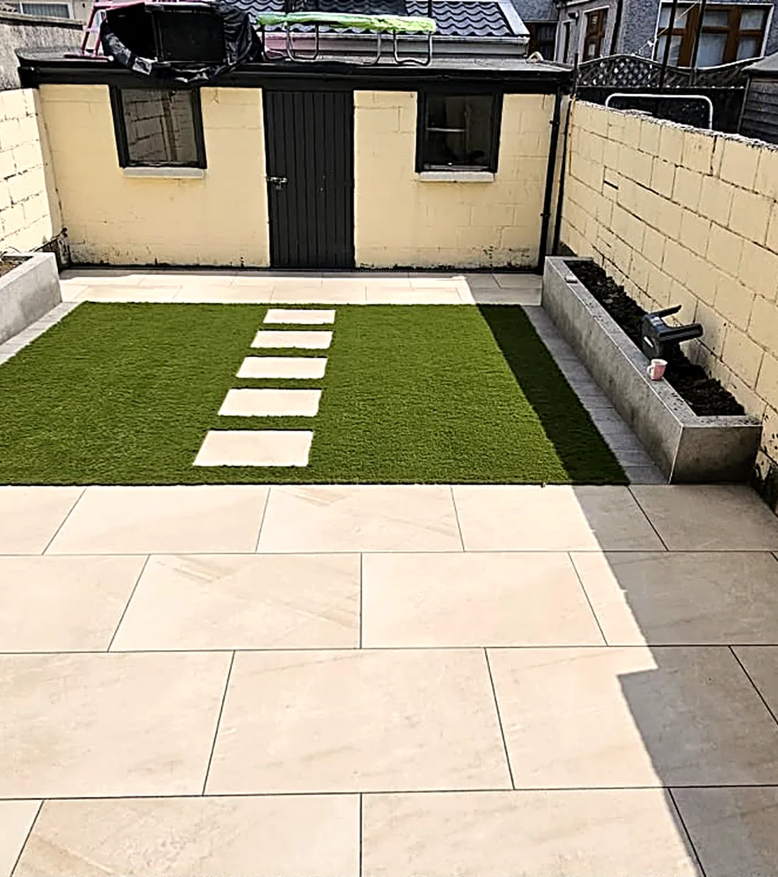 Finished porcelain courtyard with new lawn
