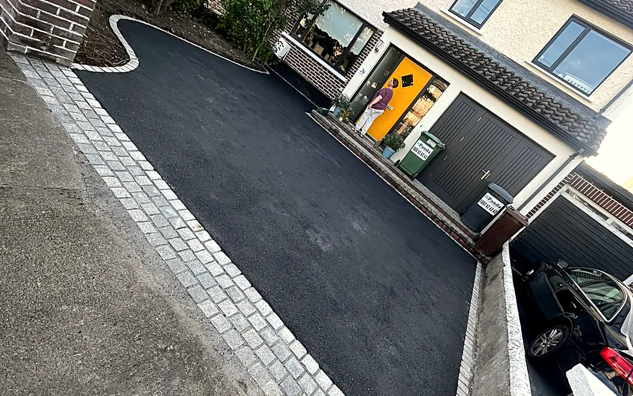 A tarmac drive with granite edging and a matching apron at the entrance.