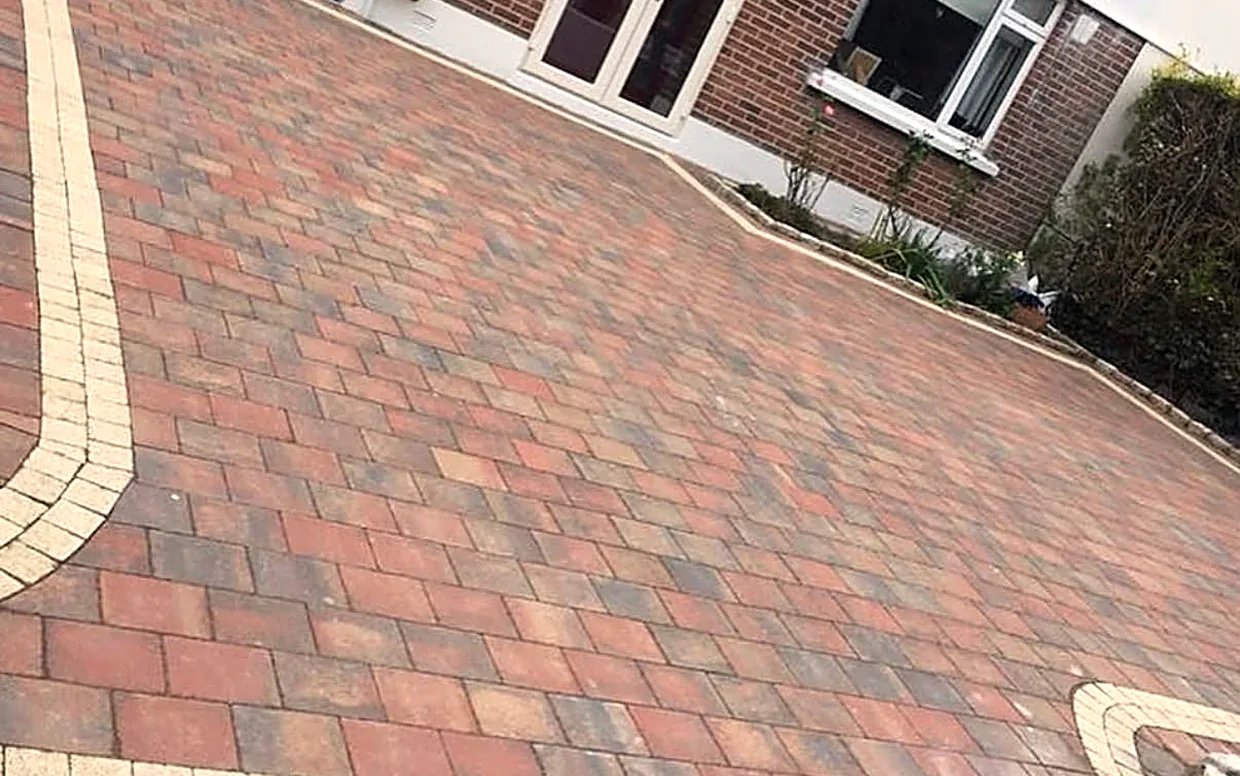A block paving driveway laid by hand over a compacted base, with a contrasting border, South Dublin.