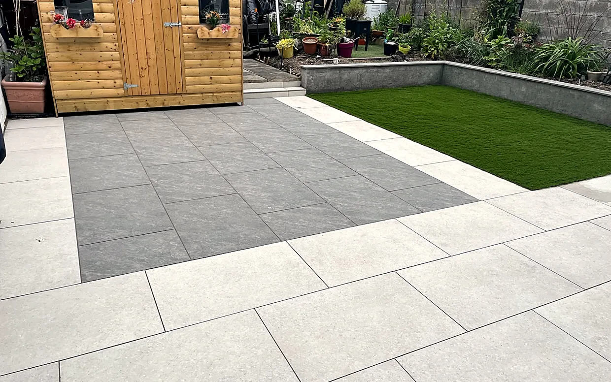 A porcelain patio with a contrasting inset panel and border, showing how colour and pattern change the cost.
