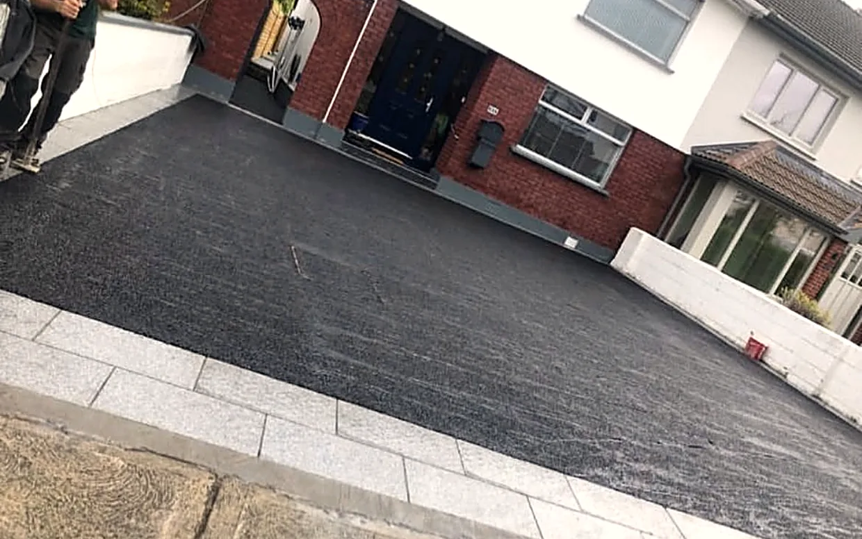 Granite edging set on concrete frames the finished tarmac, so the edges never move.