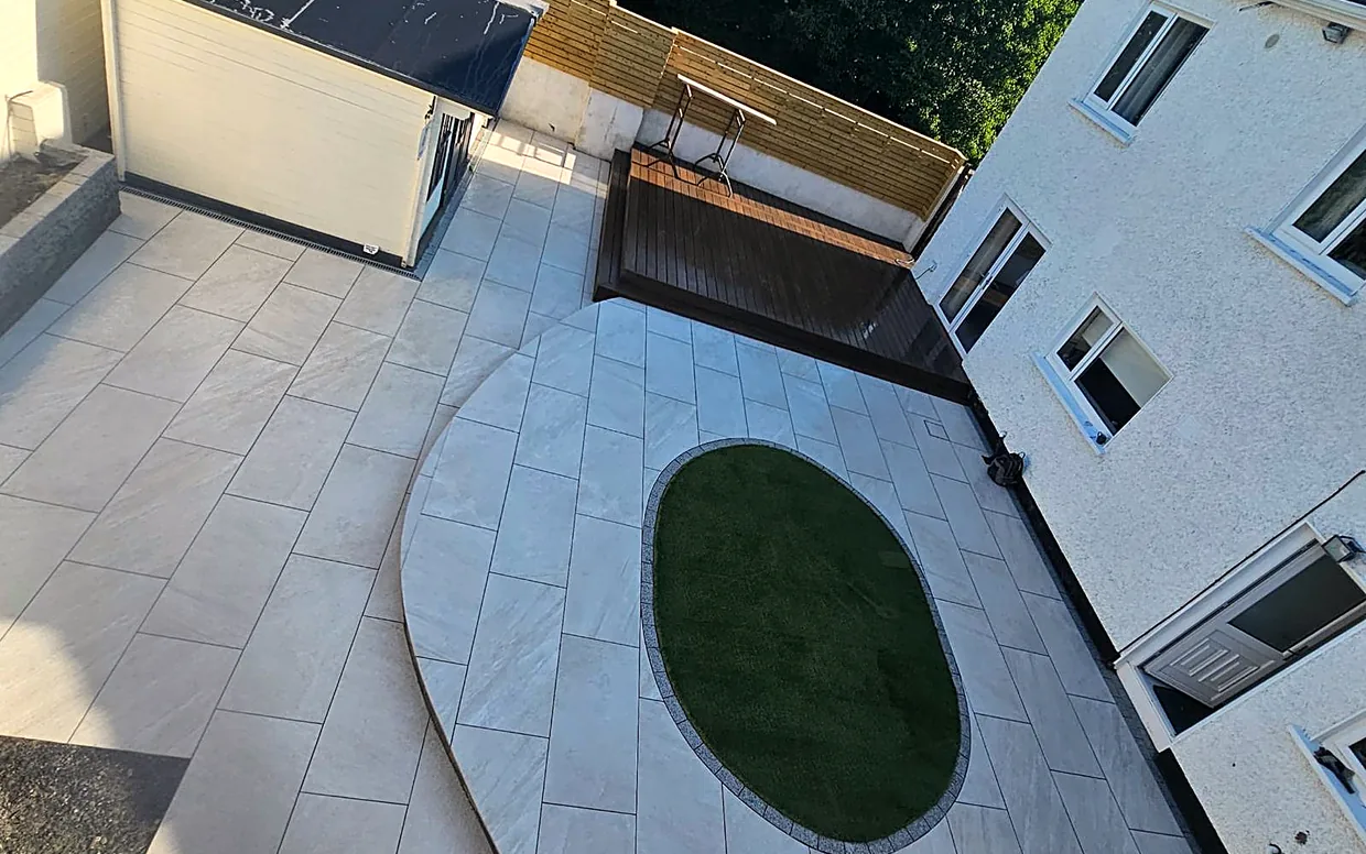 A porcelain patio, colour-stable and low-maintenance, laid on a full bound bed.