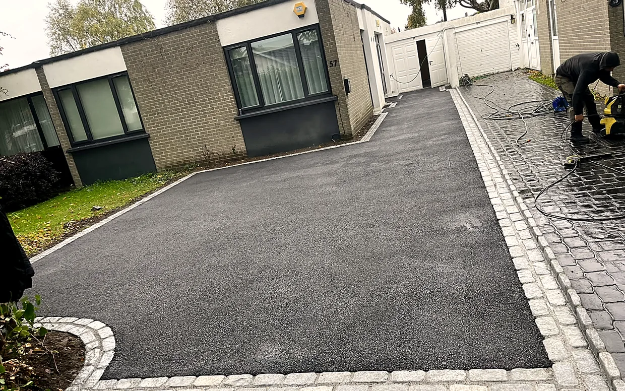 Machine-laid black macadam being rolled to a smooth, sealed finish in South Dublin.