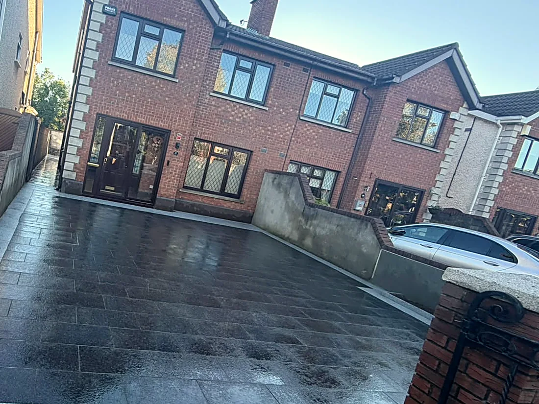 The front driveway in black granite, wide, with the silver granite border along the footpath