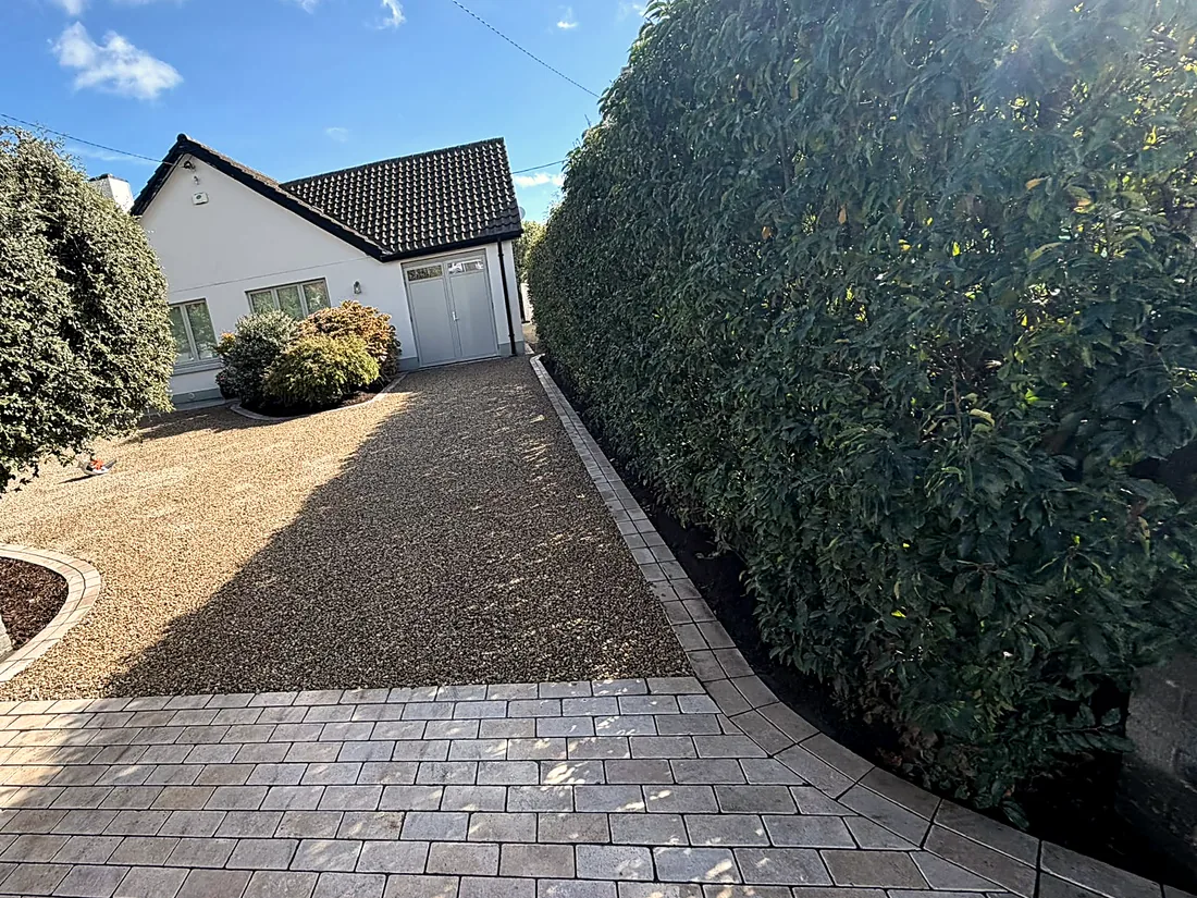 The finished drive from the gate, wider, the gravel sweeping towards the garage