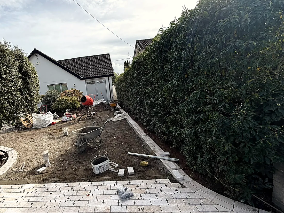 Mid-work: the Egyptian limestone cobble apron going down at the entrance