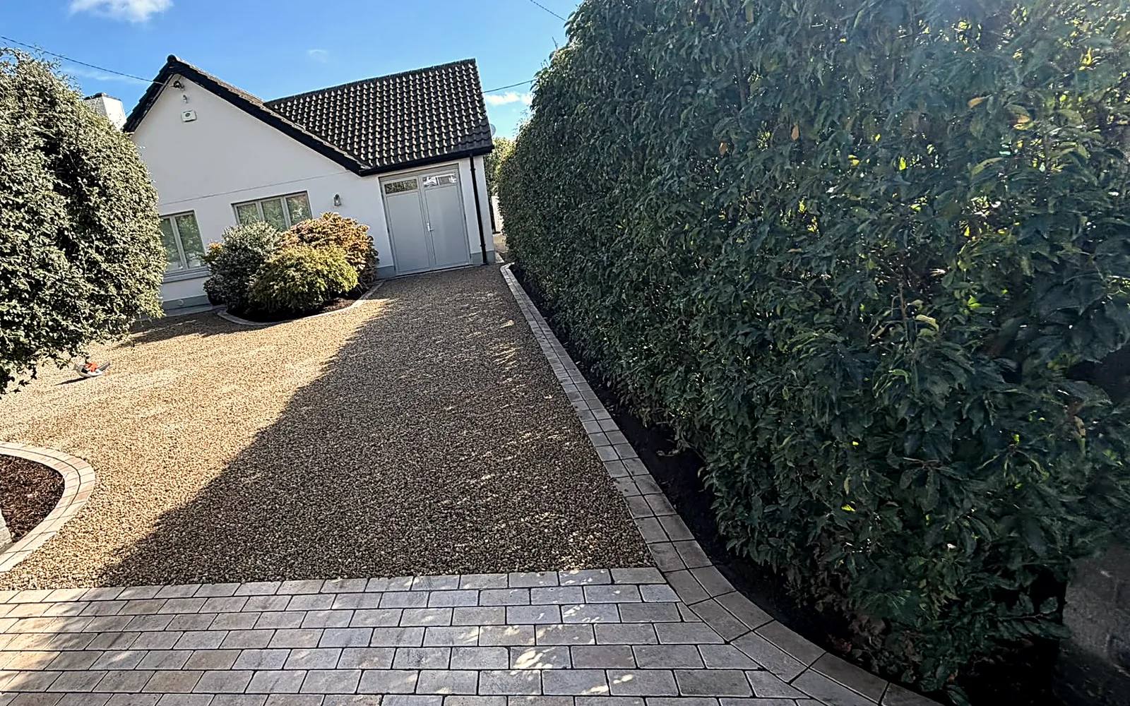 The finished drive from the gate, wider, the gravel sweeping towards the garage - after