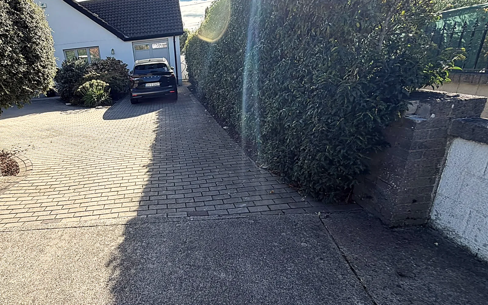 Before: the old block paving from the gate, the house and the hedge - before