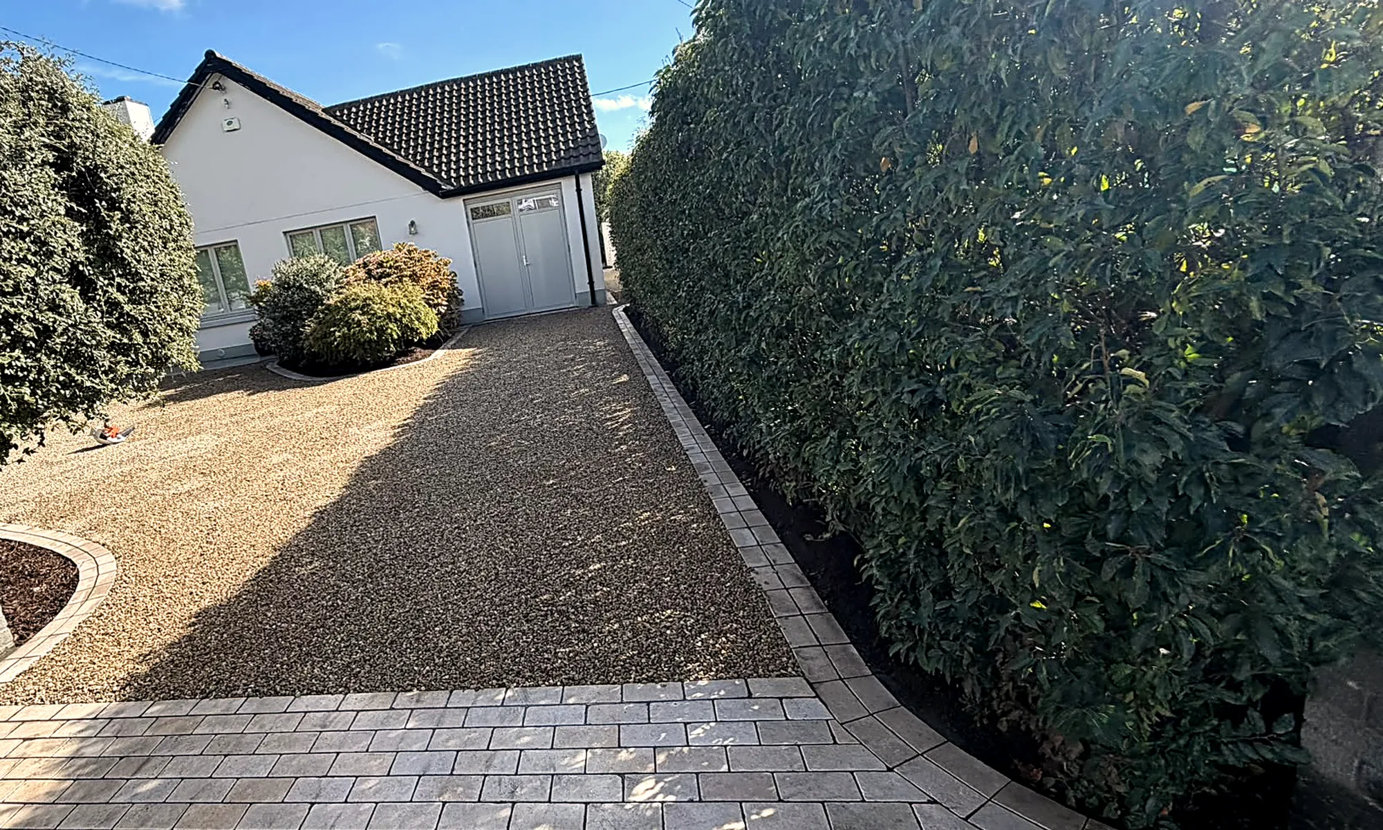 The finished drive from the gate, wider, the gravel sweeping towards the garage