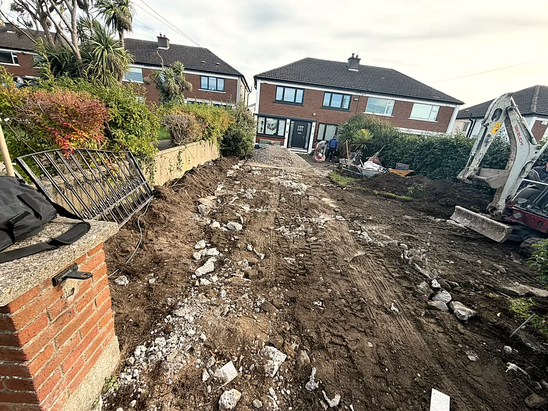 The old concrete broken out and the ground dug down, the digger at work