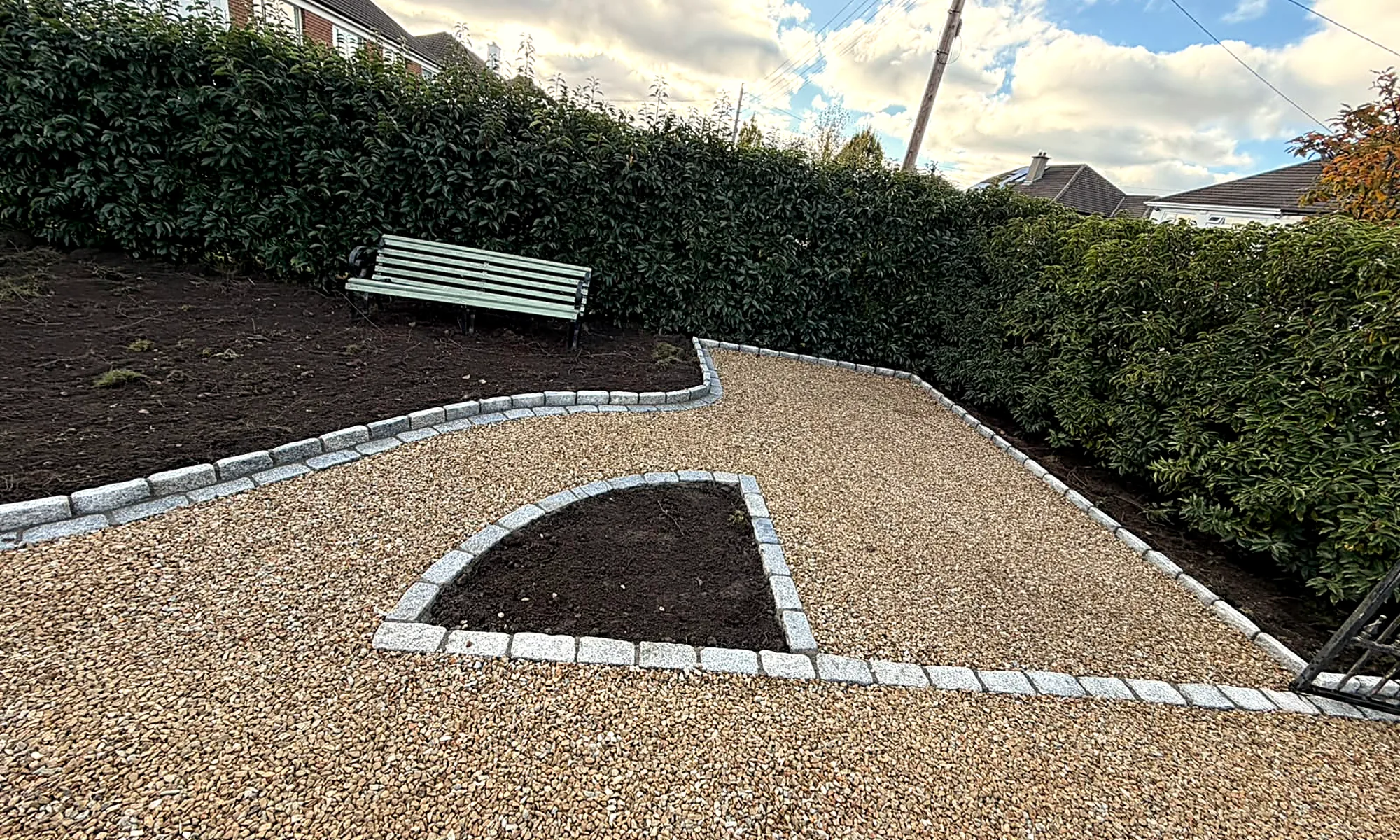 The finished gravel driveway in Leopardstown, the granite-edged bed and a bench by the hedge