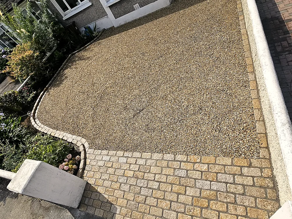 Golden gravel driveway with cobble border