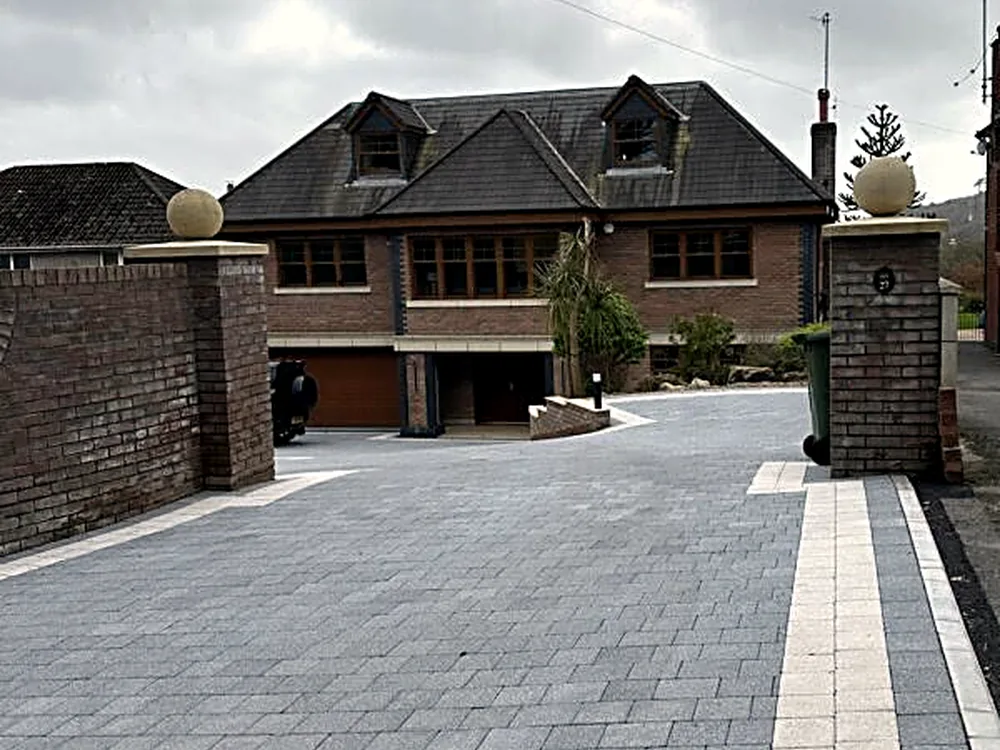 Charcoal cobblelock driveway at a detached home