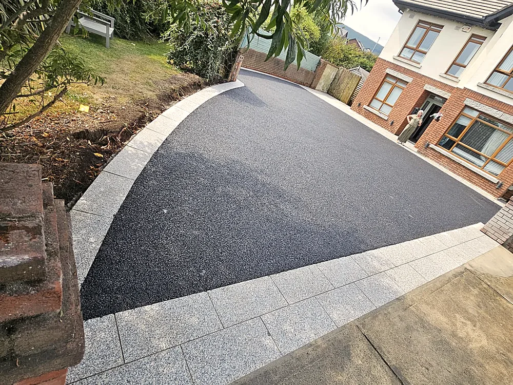 Curved tarmac driveway with silver granite border