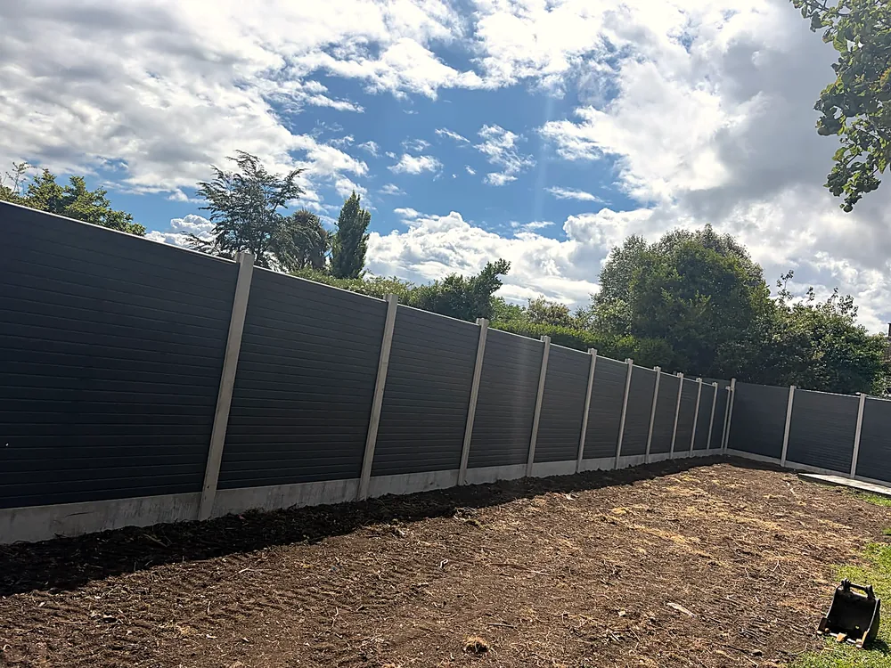 Grey composite fencing around a new garden