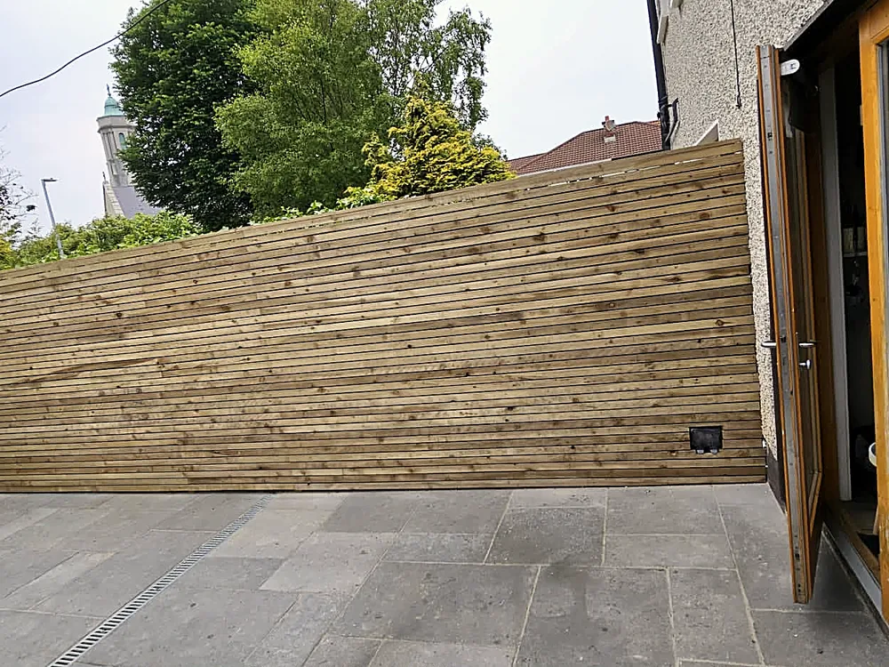 Slatted timber screening along a patio garden