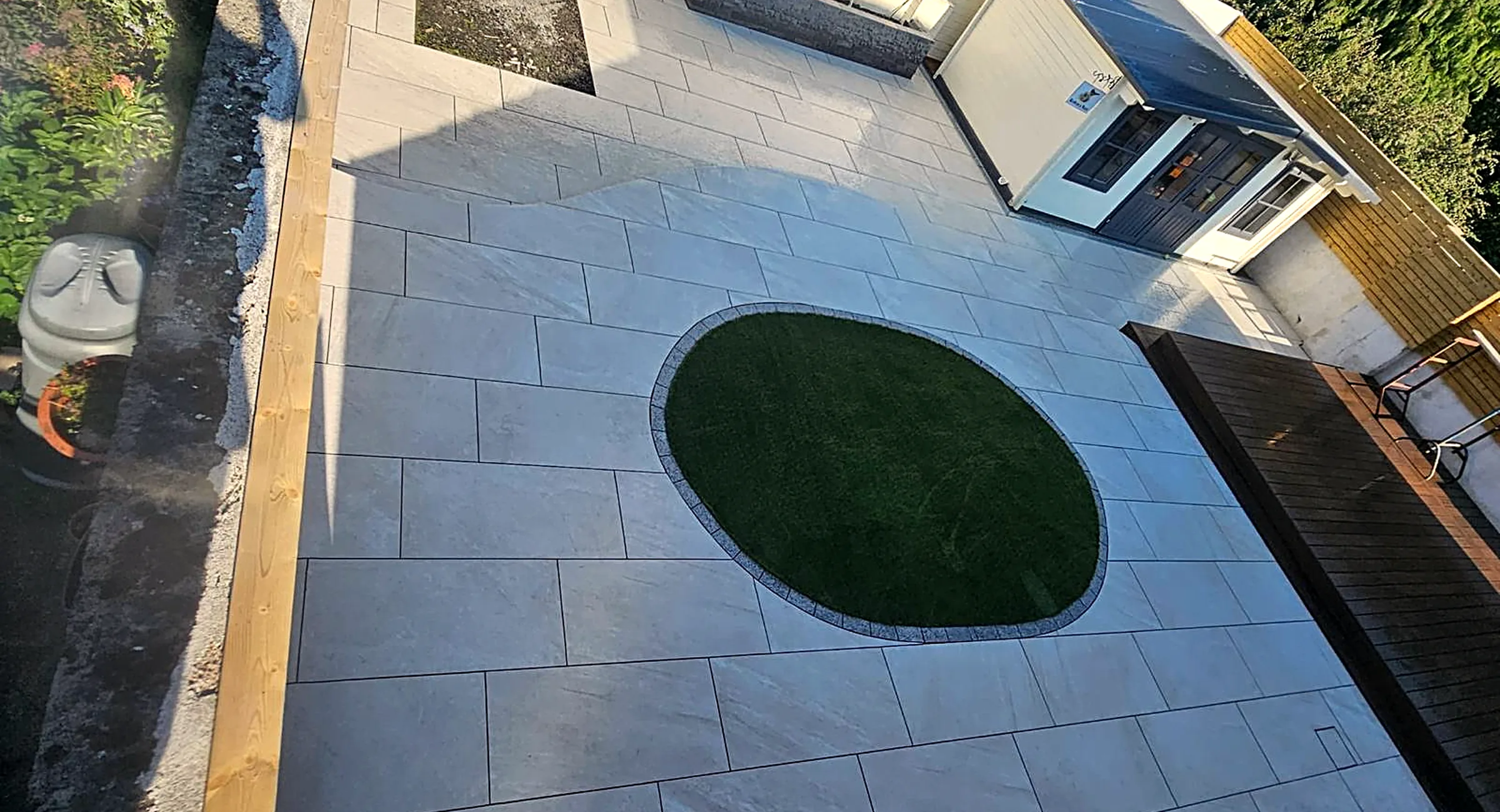 Porcelain patio with a circular lawn inset