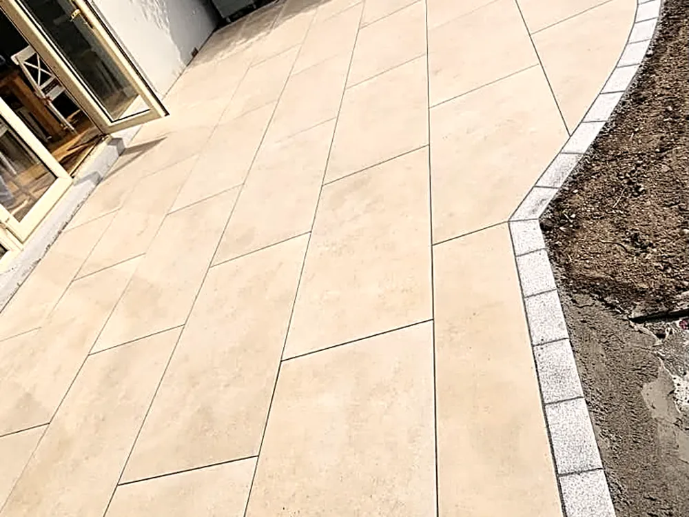 Porcelain patio framed by planting