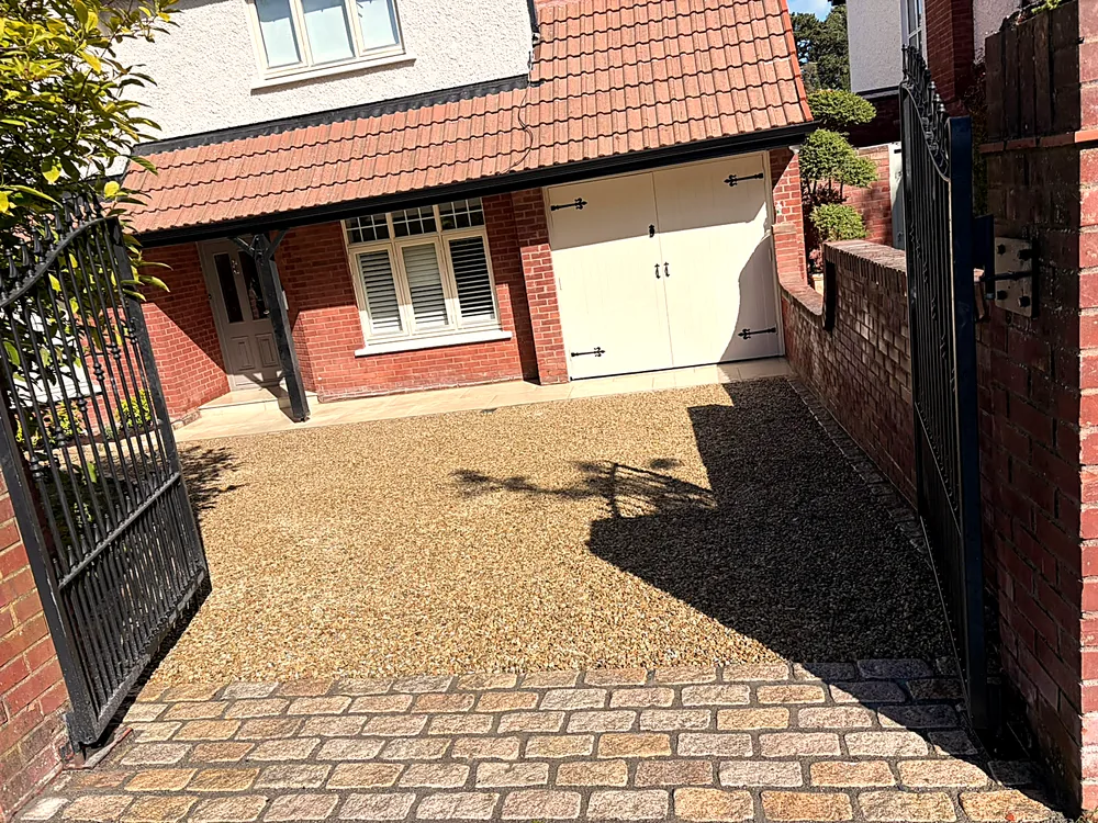 Gravel driveway at a red brick home